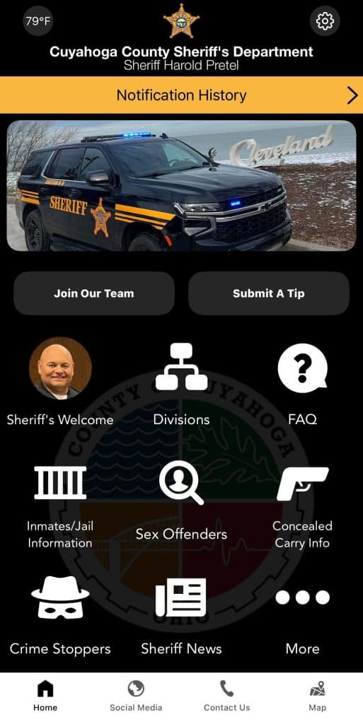 A screenshot of The Sheriff App shows “Cuyahoga County Sheriff’s Department: Sheriff Harold Pretel” at the top. Below are icons labeled: “Sheriff’s Welcome,” “Divisions,” “FAQ,” “Inmates/Jail Information,” “Sex Offenders,” “Concealed Carry Info,” “Crime Stoppers” and “Sheriff News.”
