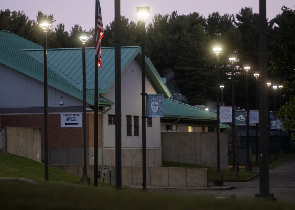 A photo shows the exterior of a residential treatment facility with a light-green roof at dawn.
