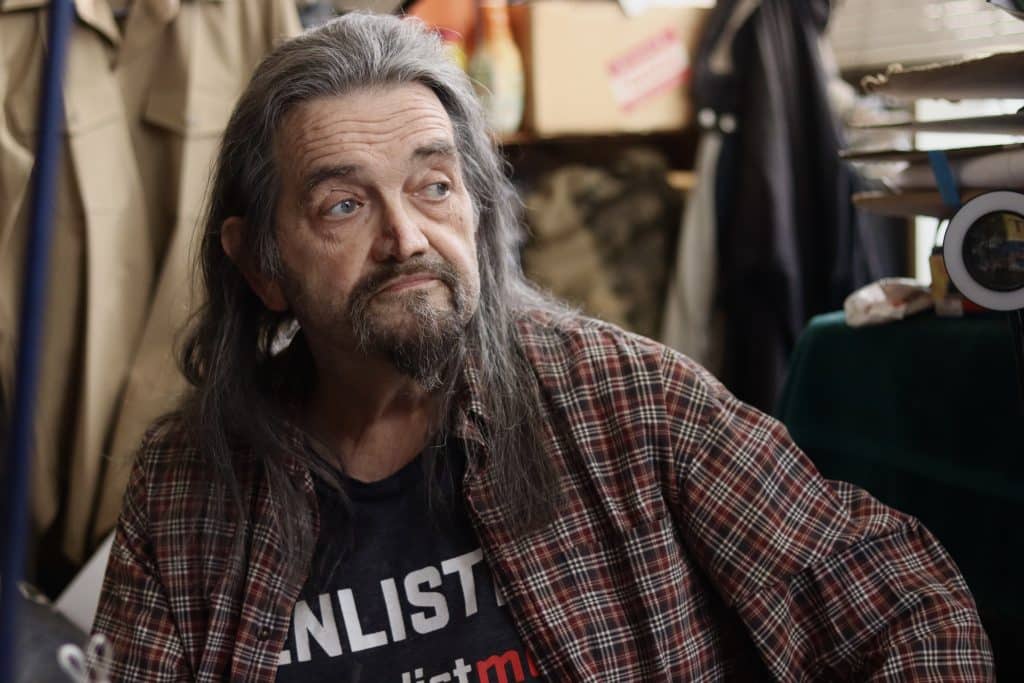 Craig Alan Nichols, an older white man, looks out the window.